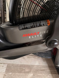 Close-up of the Assault Elite bike LCD console highlighting the integrated heart rate monitor tracking and colored zone indicators.