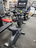 Matrix Endurance commercial stationary upright cycle bikes lined up inside a modern health club cardio training zone