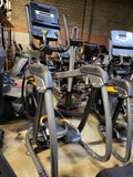Close-up of the textured, rubber-inserted foot pedals and Ergo Form stationary grips with integrated resistance and incline controls.