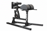 The Rogue Abram GHD 2.0 positioned next to weight racks inside a compact home garage gym
