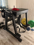 Close-up of the adjustable Rogue Z Hyper roller attachment with thick foam pads on the lower swing arm